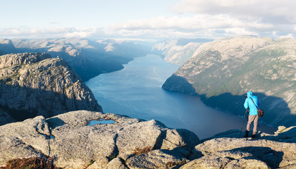 Naklejka premium Photographer taking photo of Lysefjorden fjord near Preikestolen (pulpit-rock) - famous tourist attraction in the municipality of Forsand in Rogaland county, Norway.