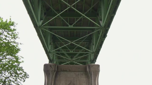 Tilt down from the underside St Johns bridge, to the unique supports that gave Cathedral Park in Portland, Oregon its name.
