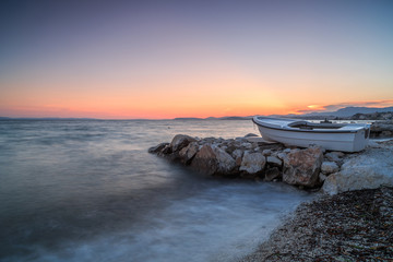 Boat on the pier at adriatic sea during sunset,long exposure