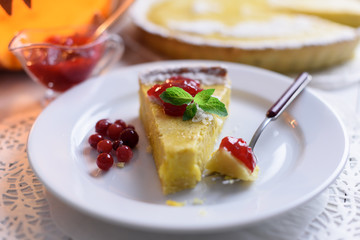 Pumpkin cake, cooked for the celebration of Halloween and decorated with cranberry and mint twig. Food photography