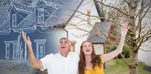 Composite image of casual couple smiling with arms raised
