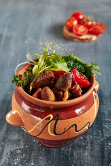 Main Course Roasted Chicken in Ceramic Pot Close Up