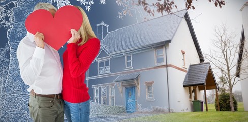 Composite image of couple embracing and holding heart over faces