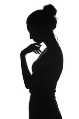 silhouette profile of a sad woman with hand near chin on a white isolated background