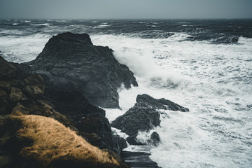 Sunrise at famous Black Sand Beach Reynisfjara in Iceland. Windy Morning. Ocean Waves. Colorful Sky. Morning Sunset.