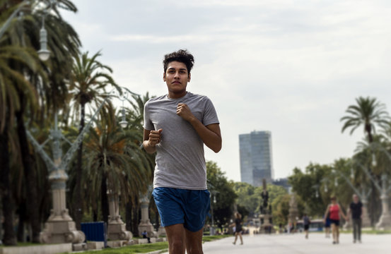 Young latin man jogging or running in a city park