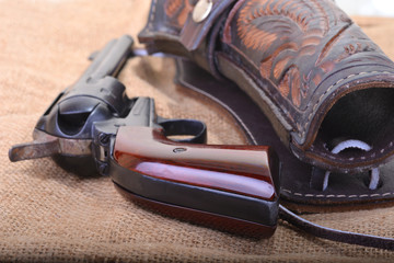 Close up of a western six shooter revolver with leather holster