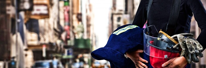 Composite image of female architect holding helmet and gloves
