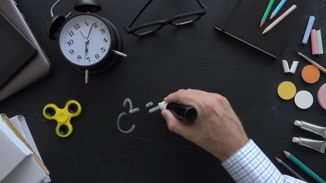 Pythagorean theorem, also known as Pythagoras's theorem, math class in the school with teacher writing mathematical formula on blackboard