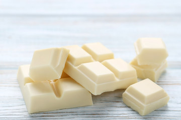 White chocolate pieces on wooden table