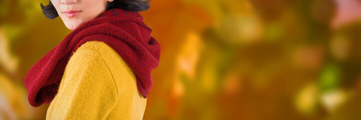 Composite image of woman in winter clothing posing against white