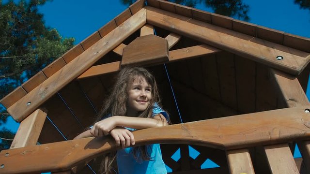 Happy little girl on the playground.
