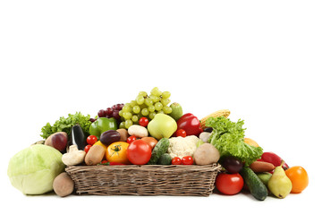 Ripe fruits and vegetables in basket on white background