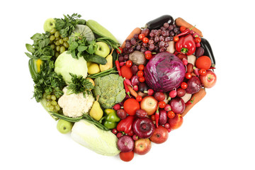 Ripe fruits and vegetables in heart shape on white background