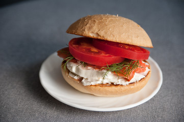 Sandwich with fresh salmon, tomato and cream cheese