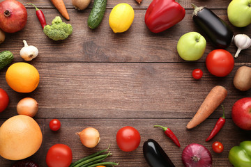 Ripe fruits and vegetables on brown wooden table