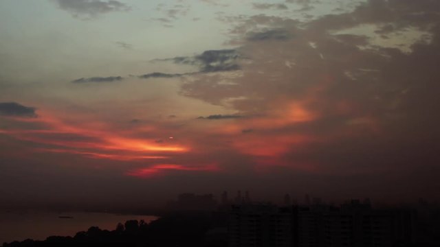 Timelapse of bloodred sunset over skyline Singapore Asia