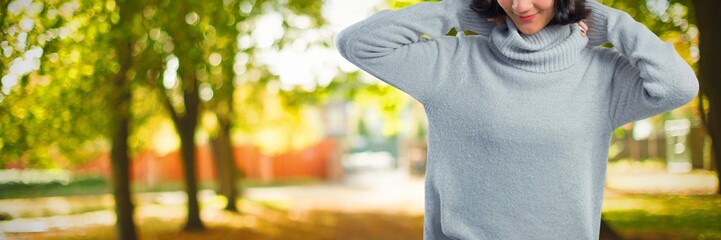 Composite image of woman in winter clothing posing against white
