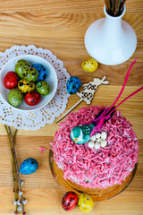Sweet and appetizing cupcake with pink sprinkling on the table