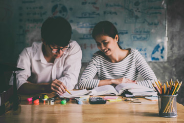 Fototapeta premium High school or college Asian student group sitting at desk in class studying and reading, doing homework and lesson practice preparing exam to entrance, education concept