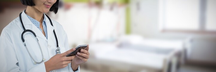 Composite image of doctor using mobile phone against grey