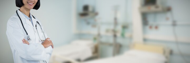 Composite image of doctor standing with arms crossed against