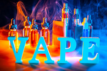 The inscription VAPE. Liquid for electronic cigarettes. Concept with electronic cigarettes....