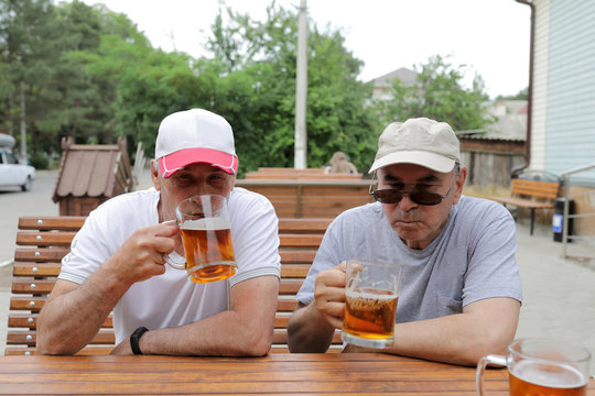 Two Senior Men Drinking Beer