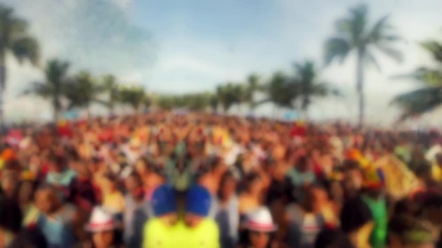 Crowd of people with palm trees in abstract defocus stylized scene of a carnival street party in Rio de Janeiro, Brazil