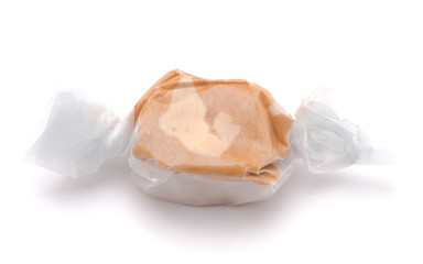 Single Piece of Tan Salt Water Taffy on a White Background