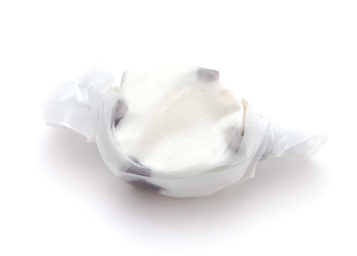 Single Piece of Black and White Salt Water Taffy on a White Background