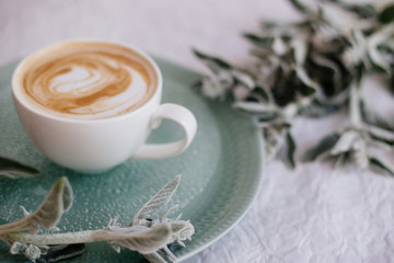 Cup of cappuccino and flowers.