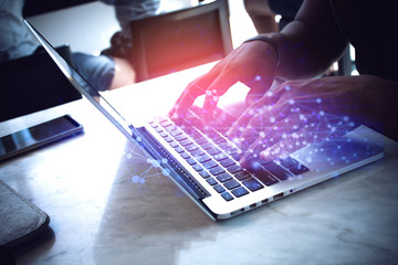 man with type on notebook computer with network connection background online