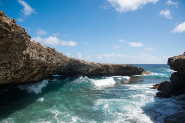 Naklejka premium Waves coming through Natural Bridge at Shete Boka natural park, Curacao