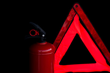 Car fire extinguisher and emergency stop sign on black background