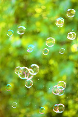 Soap bubbles on an abstract background. Pay attention to the blurred image.