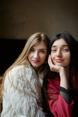 Fototapeta premium Closeup portraits of two girls having a good time together.Smile.Concept frienship.Girlfreind..Blonde and brunette
