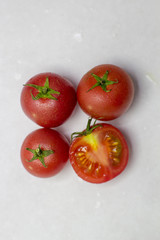 Fresh tomatoes on white background. Top view. With splashes of water.