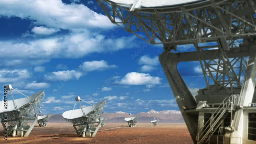 Poster camera moving to reveal several radio telescopes. beautiful clouds move across horizon. advanced tec