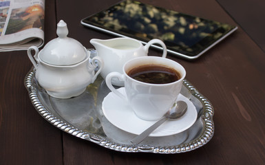Concept of coffee break with newspaper and tablet