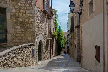 Narrow street, stairs and house in the center in Girona, Spain.