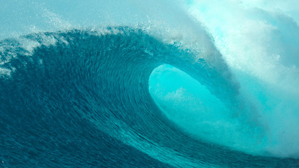 CLOSE UP: Big tube wave crashes on the sunny coast of a remote tropical island.