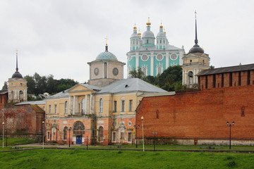 Fototapeta na wymiar Russia - the Smolensk fortress wall and the Church of Hodegetria on the background of the Uspensky Cathedral in the summer cloudy day