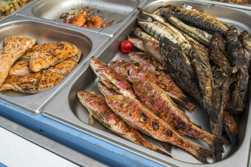 fish cooked fire, fish grilled on the counter in the store