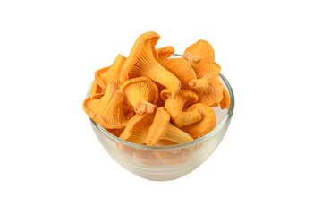 Chanterelle mushrooms lie in transparent glass bowl isolated on white background