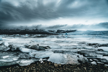 Fjallsarlon Jokulsarlon Huge glacier and mountains in Iceland Vatnajokull glacier aerial drone image with clouds and blue sky. Dramatic winter scene of Vatnajokull National Park, Iceland, Europe
