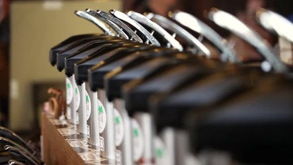 Close-up row of coffee flavor pumps in a coffee shop