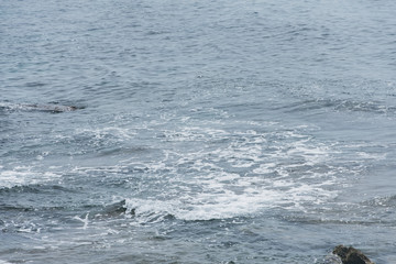 Coast. Sea waves. Stone beach. Mediterranean Sea. Water splashes. Place for inspiration. Background for travel company. Rest on the sea.