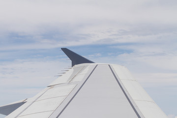 Fototapeta na wymiar The wing of a flying plane