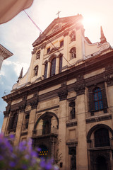 Catholic church of St. Peter and Paul in Lviv, Ukraine. Ancient cathedral on sky background with flowers in front